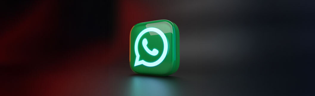 WhatsApp-Logo in grünem Kreis auf dunklem Hintergrund, symbolisiert Messaging-Dienst.